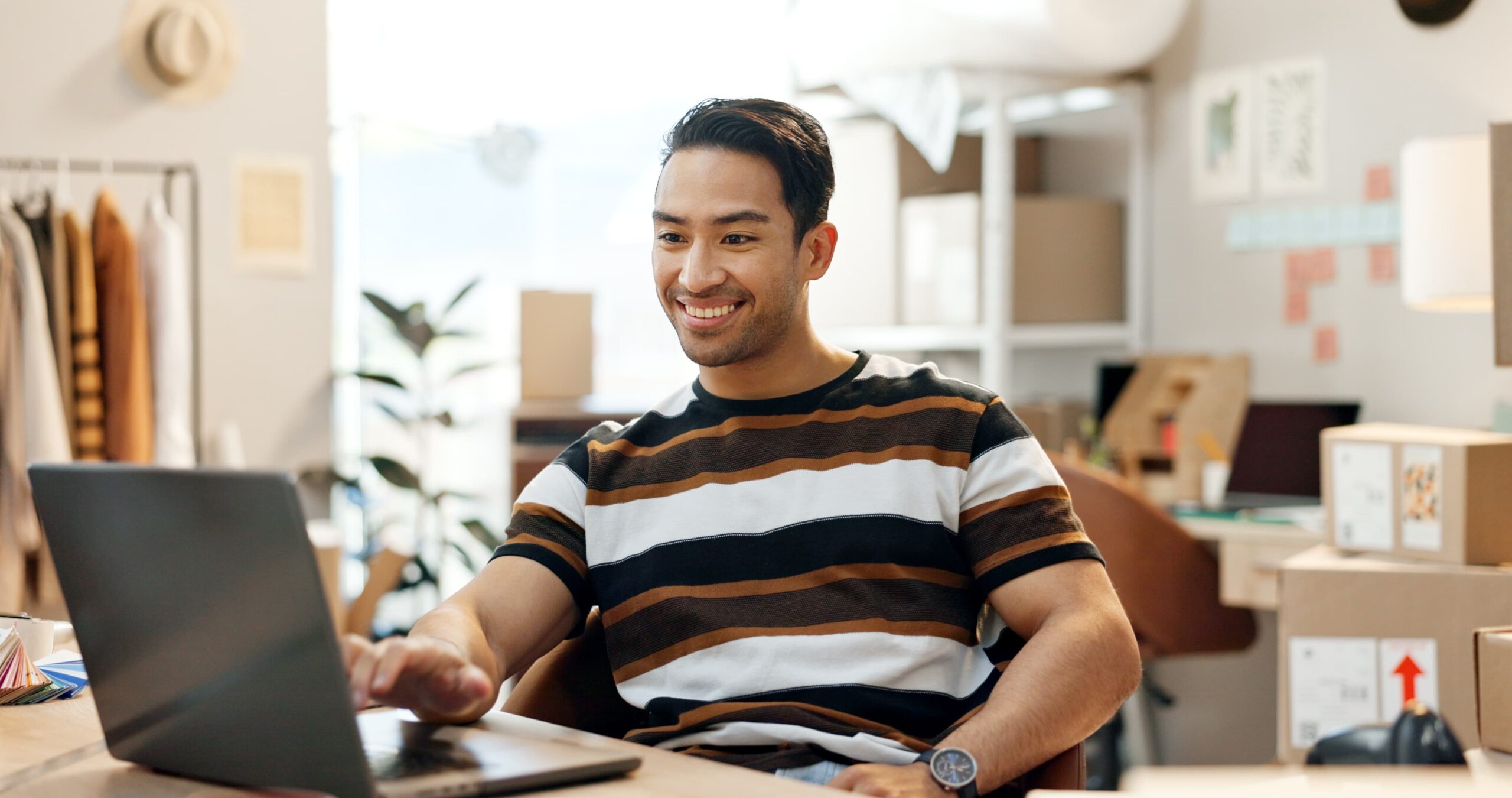 Business owner smiling while reviewing increased sales metrics