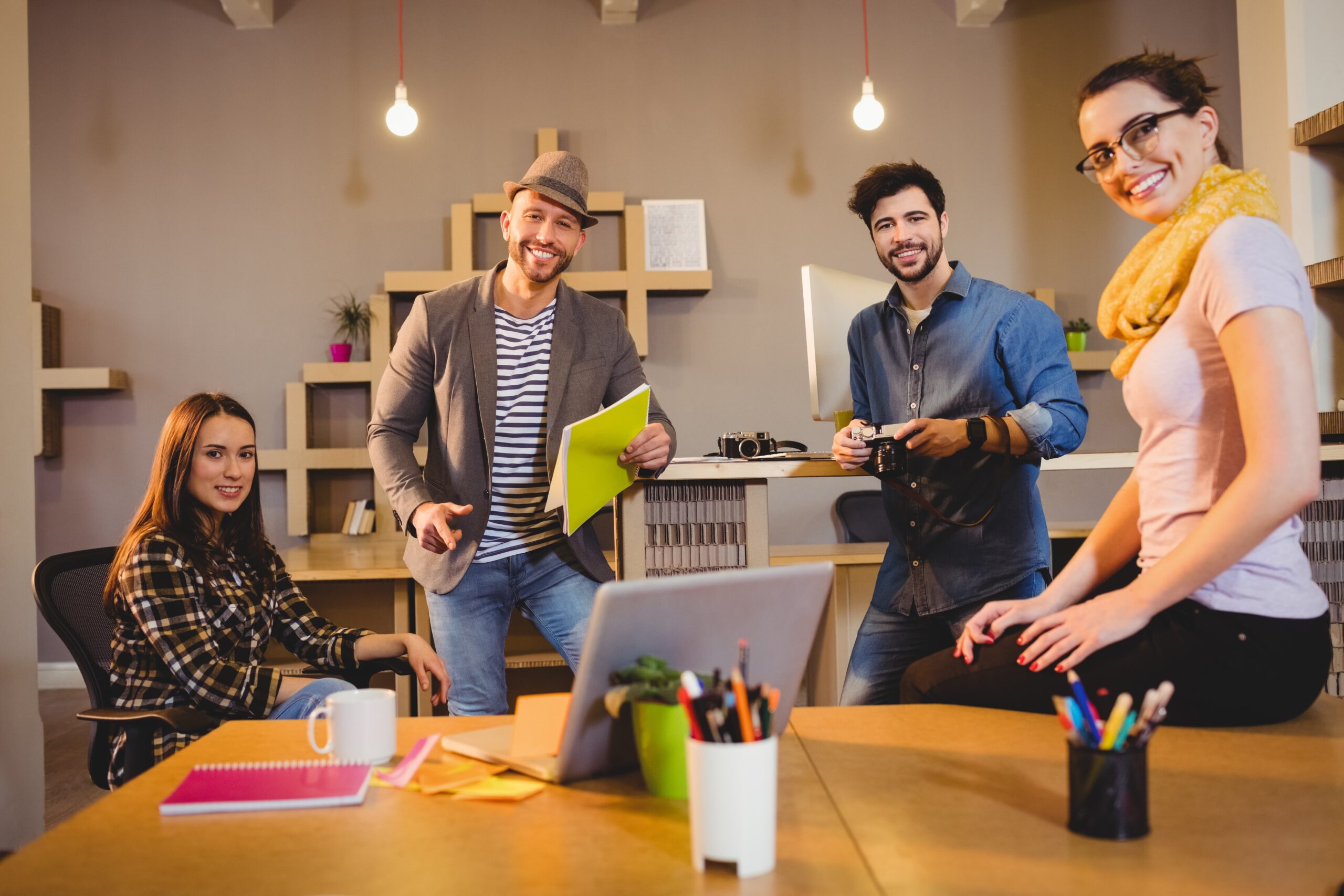 Creative team collaborating during a strategy meeting in a modern ad agency workspace