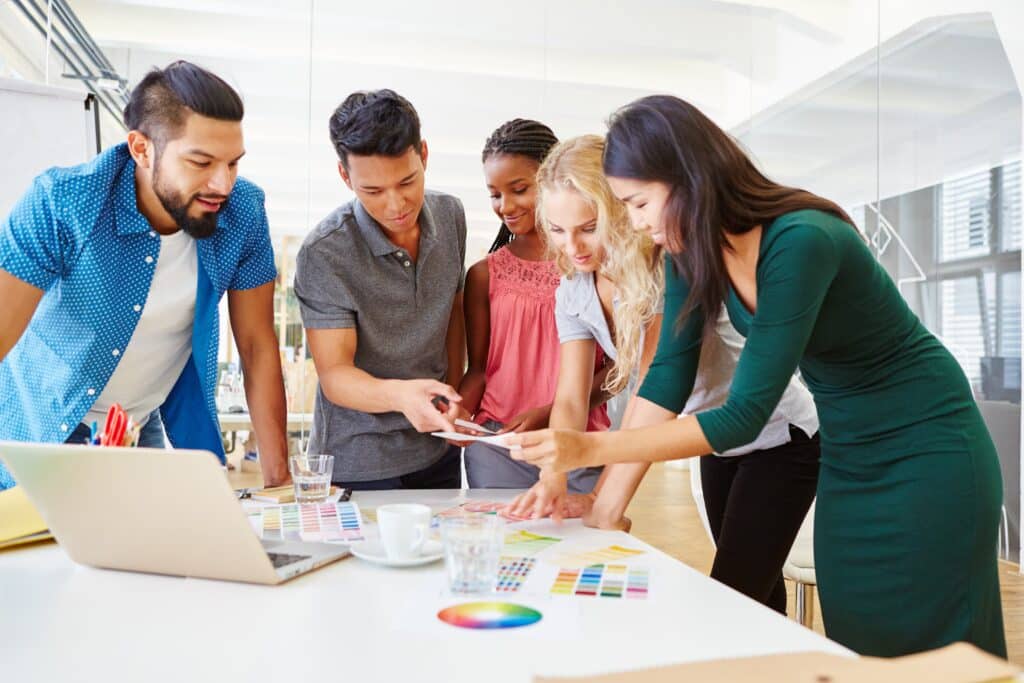 Creative team reviewing a visual identity system brand framework for consistency across platforms